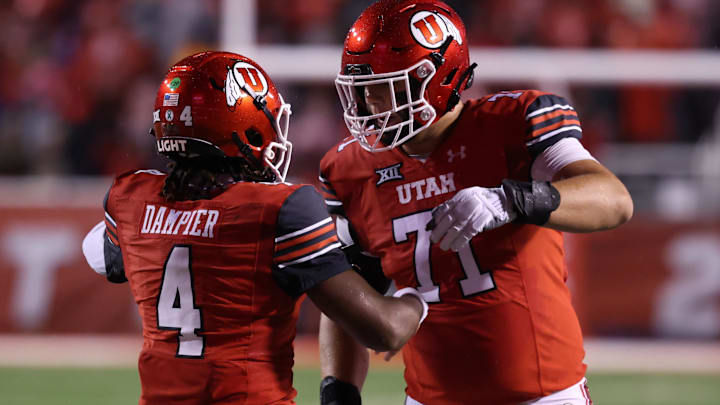 Utah Utes QB Devon Dampier celebrates scoring a touchdown against the Arizona State Sun Devils with OT Caleb Lomu. Utah Utes QB Devon Dampier celebrates scoring a touchdown against the Arizona State Sun Devils with OT Caleb Lomu.