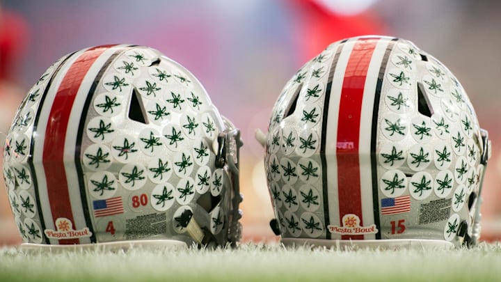 Jan 1, 2016; Glendale, AZ, USA; Two Ohio State Buckeyes helmets sit on the field during warmups before the 2016 Fiesta Bowl between the Notre Dame Fighting Irish and the Ohio State Buckeyesat University of Phoenix Stadium. Mandatory Credit: Matt Cashore-Imagn Images