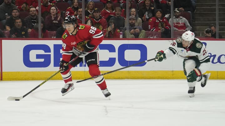 Oct 4, 2024; Chicago, Illinois, USA; Minnesota Wild defenseman Jonas Brodin (25) defends Chicago Blackhawks center Connor Bedard (98) during the first period at United Center. Mandatory Credit: David Banks-Imagn Images