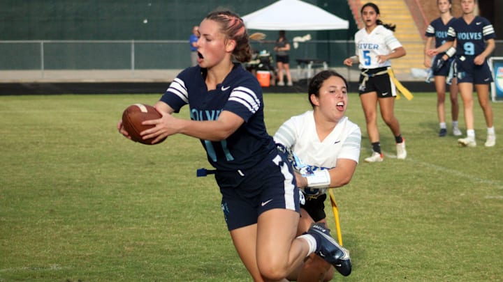 Newsome receiver Madison Ludwig (11) tries to elude a Spanish River flag pull during a Florida High School Athletic Association Class 2A flag football semifinal at Mandarin High School in Jacksonville on May 13, 2022. [Clayton Freeman/Florida Times-Union]
