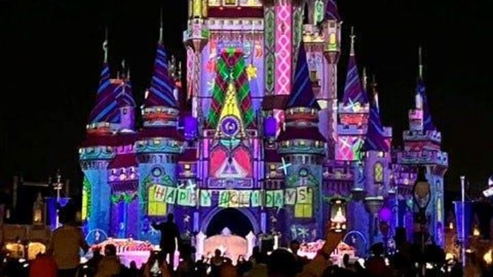 Cinderella Castle glows during a showing of \"Frozen Holiday Surprise\" at Walt Disney World's Magic