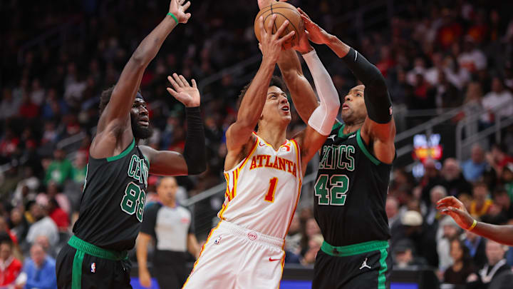 Nov 4, 2024; Atlanta, Georgia, USA: Atlanta Hawks forward Jalen Johnson (1) is defended by Boston Celtics center Neemias Queta (88) and center Al Horford (42) in the third quarter at State Farm Arena. Mandatory Credit: Brett Davis-Imagn Images