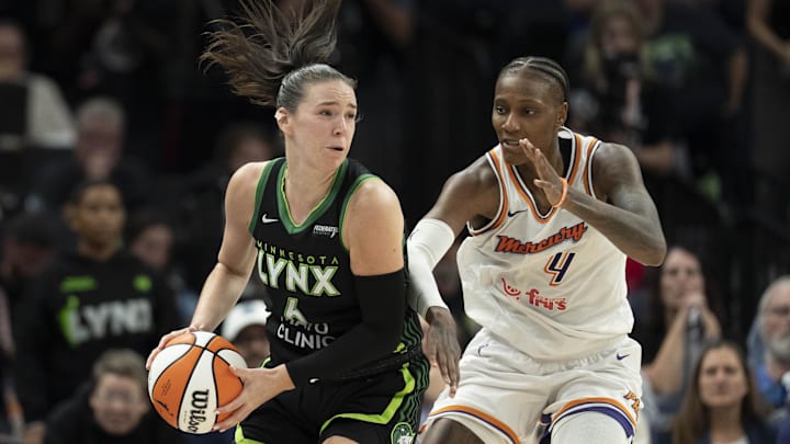 Sep 23, 2025; Minneapolis, Minnesota, USA; Minnesota Lynx forward Bridget Carleton (6) dribbles around Phoenix Mercury forward Natasha Mack (4) in the second half during game two of the second round for the 2025 WNBA Playoffs at Target Center. Mandatory Credit: Jesse Johnson-Imagn Images