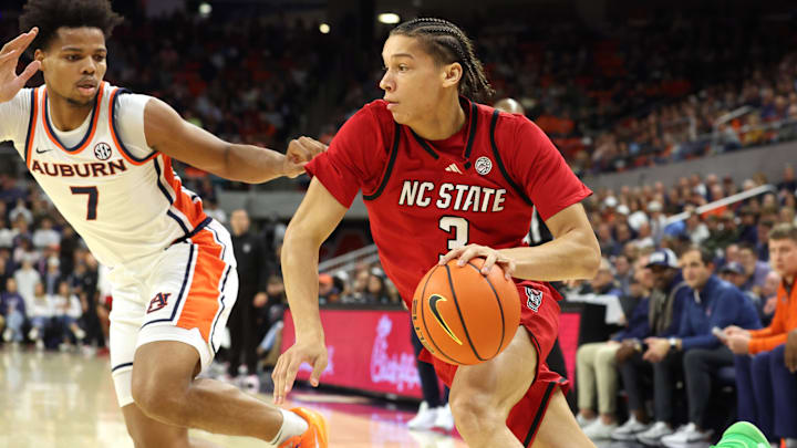 Dec 3, 2025; Auburn, Alabama, USA;  NC State Wolfpack guard Matt Able (3) drives against Auburn Tigers guard Keyshawn Hall (7) during the first half at Neville Arena. Mandatory Credit: John Reed-Imagn Images