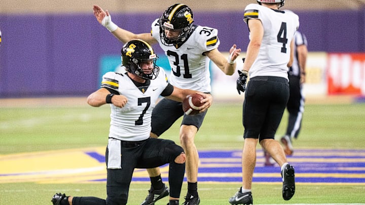 Southeast Polk's Holden Hansen (7) celebrates a semifinal win over Iowa City Liberty with his teammates Sam Reed (31) and Kaden Hills (4) on Friday, Nov. 15, 2024, at the UNI-Dome in Cedar Falls, IA.