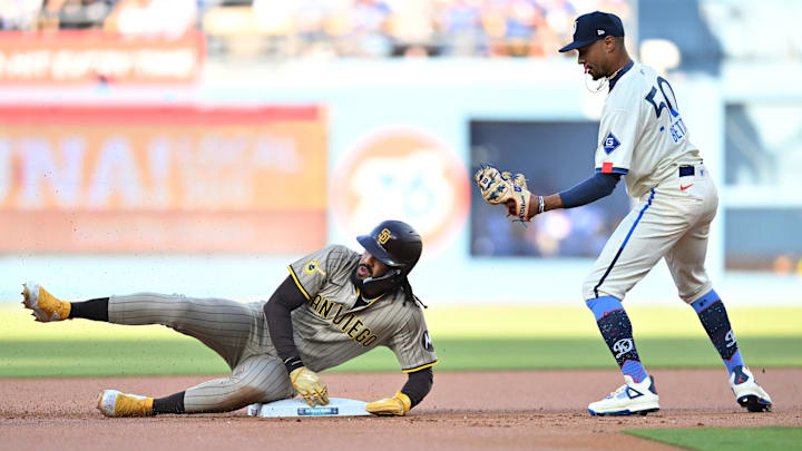 Aug 16, 2025; Los Angeles, California, USA; Los Angeles Dodgers shortstop Mookie Betts (50) takes out San Diego Padres outfielder Fernando Tatis Jr. (23) at second base during the first inning at Dodger Stadium. Mandatory Credit: William Liang-Imagn Images
