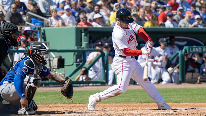 Mar 2, 2025; Fort Myers, Florida, USA; Boston Red Sox Alex Bregman (2) hits a single during the first inning of their game with the New York Mets at JetBlue Park at Fenway South.
