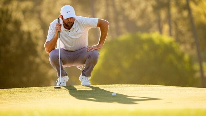 Apr 13, 2024; Augusta, Georgia, USA; Scottie Scheffler lines up his putt on the No. 17 green during