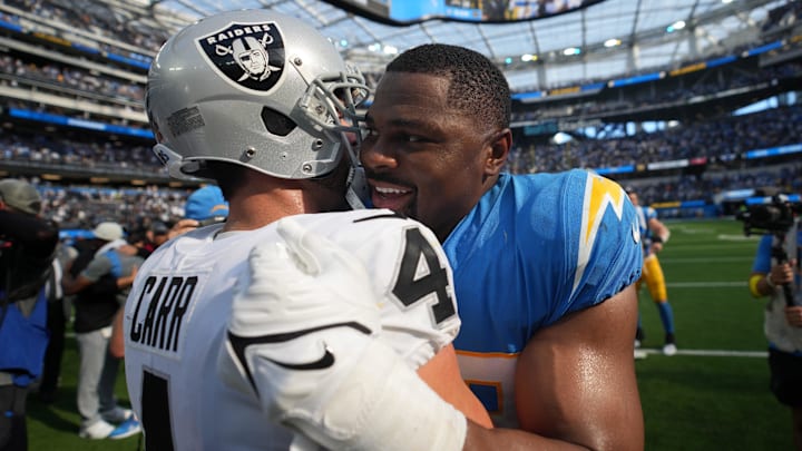 Sep 11, 2022; Inglewood, California, USA; Las Vegas Raiders quarterback Derek Carr (4) and Los Angeles Chargers linebacker Khalil Mack (52) embrace after the game at SoFi Stadium. Mandatory Credit: Kirby Lee-Imagn Images