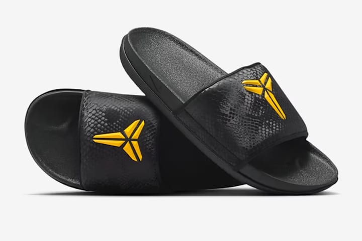 purple nike slides with gold check