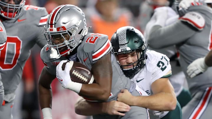 Nov 11, 2023; Columbus, Ohio, USA; Ohio State Buckeyes running back Evan Pryor (21) runs the ball as Michigan State Spartans linebacker Cal Haladay (27) makes the tackle during the fourth quarter at Ohio Stadium. Mandatory Credit: Joseph Maiorana-Imagn Images