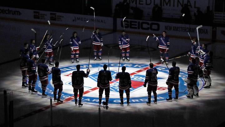Jan 14, 2021; New York, NY, USA; New York Rangers players huddle around the center ice logo as they prepare for the home opener against the New York Islanders at Madison Square Garden. Jan 14, 2021; New York, NY, USA; New York Rangers players huddle around the center ice logo as they prepare for the home opener against the New York Islanders at Madison Square Garden.