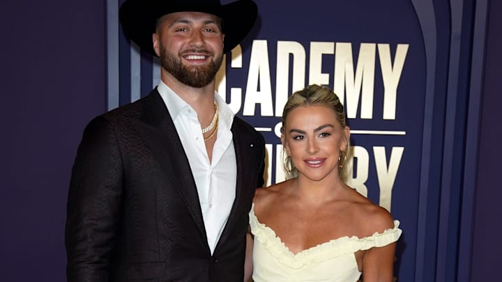 Jake Ferguson and Haley Cavinder walk the carpet at the 59th ACM Awards at the Ford Center at the Star in Frisco, Texas.