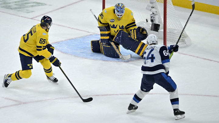 Feb 15, 2025; Montreal, Quebec, CAN; [Imagn Images direct customers only] Team Finland forward Mikael Granlund (64) scores the winning goal against Team Sweden goalie Linus Ullmark (35) in the overtime period during a 4 Nations Face-Off ice hockey game at the Bell Centre. Mandatory Credit: Eric Bolte-Imagn Images