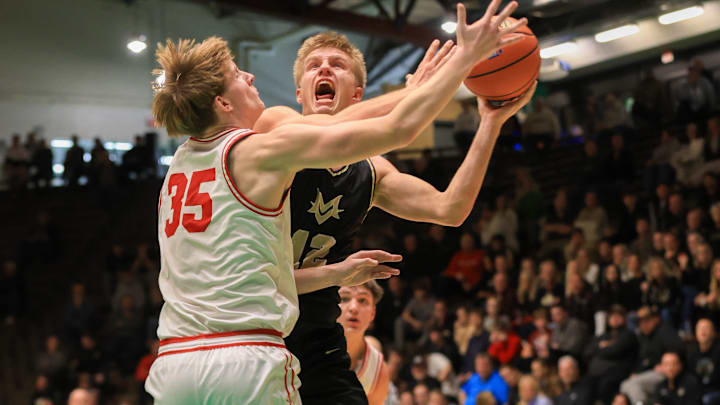 Mt. Vernon's Luke Ertel (12) drives in for a shot.