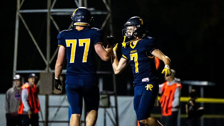 Iowa City Regina's Jackson Naeve, right, celebrates a touchdown with teammate Noah Clark (77) during a first round Class 1A high school football playoff game against Eddyville-Blakesburg-Fermont, Friday, Oct. 20, 2023, at Regina Catholic High School in Iowa City, Iowa. Iowa City Regina's Jackson Naeve, right, celebrates a touchdown with teammate Noah Clark (77) during a first round Class 1A high school football playoff game against Eddyville-Blakesburg-Fermont, Friday, Oct. 20, 2023, at Regina Catholic High School in Iowa City, Iowa.