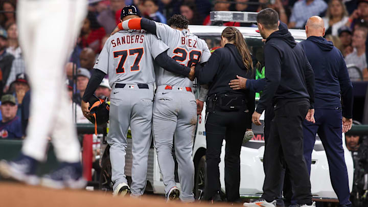 Apr 28, 2026; Atlanta, Georgia, USA; Detroit Tigers center fielder Javier Baez (28) is assisted by first base coach Anthony Sanders (77) after an injury against the Atlanta Braves in the fifth inning at Truist Park. Mandatory Credit: Brett Davis-Imagn Images