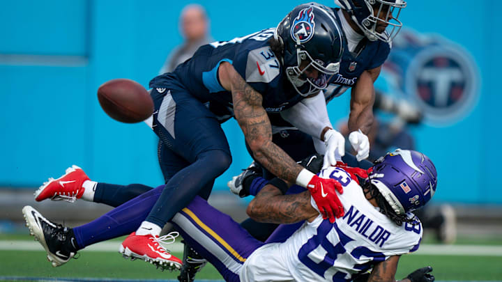 Tennessee Titans safety Amani Hooker and cornerback Darrell Baker Jr. break up a pass in the end zone.