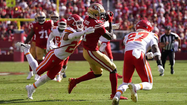 Oct 20, 2024; Santa Clara, California, USA; San Francisco 49ers wide receiver Brandon Aiyuk (11) catches a pass between Kansas City Chiefs cornerback Trent McDuffie (22) and safety Chamarri Conner (27) in the second quarter at Levi's Stadium. Mandatory Credit: Cary Edmondson-Imagn Images