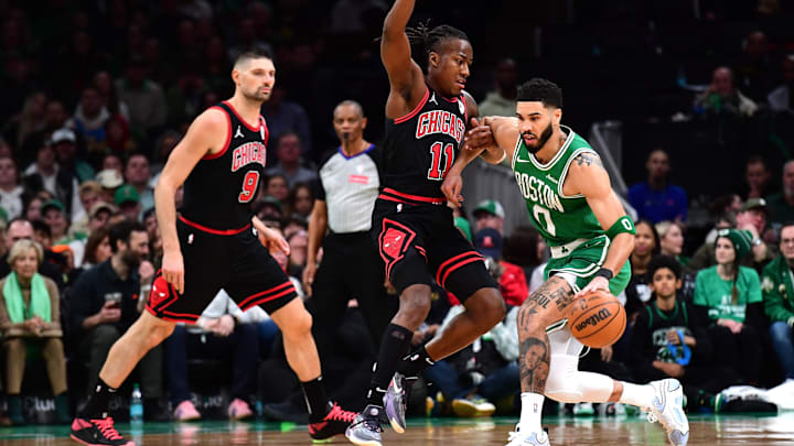 Jan 29, 2025; Boston, Massachusetts, USA; Chicago Bulls guard Ayo Dosunmu (11) grabs the arm of Boston Celtics forward Jayson Tatum (0) during the second half at TD Garden. Mandatory Credit: Bob DeChiara-Imagn Images