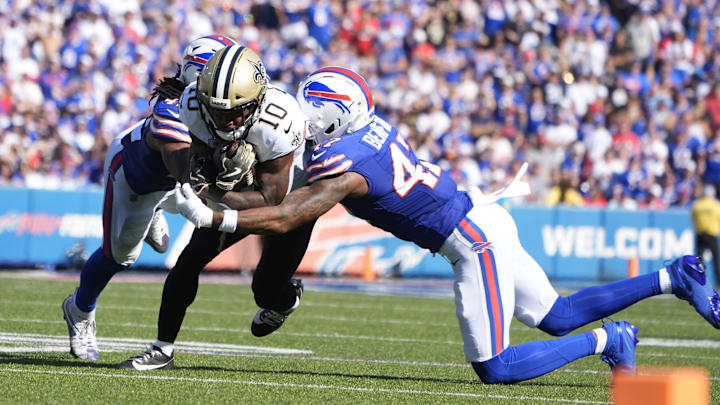 Sep 28, 2025; Orchard Park, New York, USA;  New Orleans Saints wide receiver Brandin Cooks (10) is tackled by Buffalo Bills cornerback Christian Benford (47) and linebacker Dorian Williams (42) during the fourth quarter at Highmark Stadium