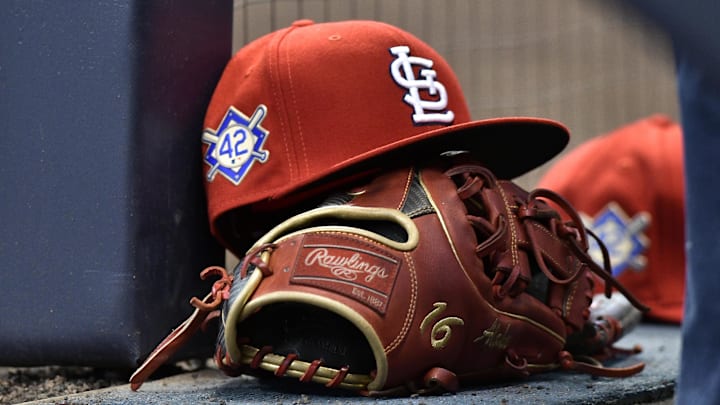 Apr 15, 2019; Milwaukee, WI, USA; A cap rests on the dug out wall with the number 42 on the hat in honor of Major League Baseball   s Jackie Robinson Day. Mandatory Credit: Michael McLoone-Imagn Images