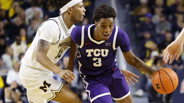Nov 15, 2024; Ann Arbor, Michigan, USA;  TCU Horned Frogs guard Vasean Allette (3) dribbles against Michigan Wolverines guard Rubin Jones (15) in the second half at Crisler Center. Mandatory Credit: Rick Osentoski-Imagn Images