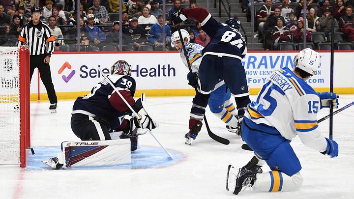 Oct 3, 2026; Denver, Colorado, USA; St. Louis Blues right winger Dalibor Dvorsky (15) scores past Colorado Avalanche goalie Mackenzie Blackwood (39) during the third period at Ball Arena. Mandatory Credit: Christopher Hanewinckel-Imagn Images