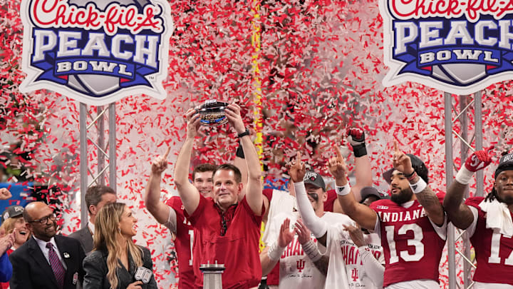Jan 9, 2026; Atlanta, GA, USA; Indiana Hoosiers head coach Curt Cignetti raises the trophy after the 2025 Peach Bowl and semifinal game of the College Football Playoff against the Oregon Ducks at Mercedes-Benz Stadium. Jan 9, 2026; Atlanta, GA, USA; Indiana Hoosiers head coach Curt Cignetti raises the trophy after the 2025 Peach Bowl and semifinal game of the College Football Playoff against the Oregon Ducks at Mercedes-Benz Stadium.