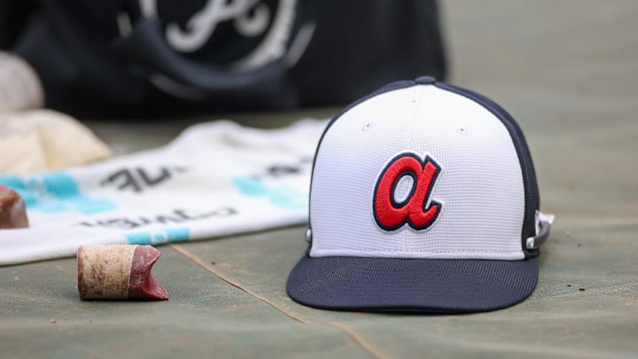 Apr 10, 2024; Atlanta, Georgia, USA; A detailed view of an Atlanta Braves hat on the field during batting practice at Truist Park. The game against the New York Mets was postponed due to impending weather. Mandatory Credit: Brett Davis-Imagn Images