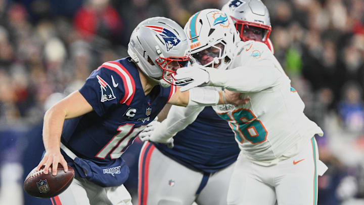 New England Patriots quarterback Drake Maye (10) scrambles against Miami Dolphins linebacker Quinton Bell (56) during the first quarter at Gillette Stadium in the 2025 season finale.