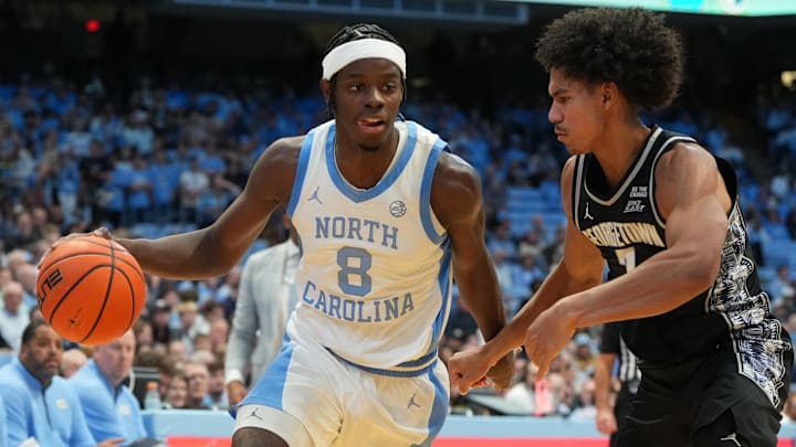 Dec 7, 2025; Chapel Hill, North Carolina, USA; North Carolina Tar Heels forward Caleb Wilson (8) with the ball as Georgetown Hoyas forward Isaiah Abraham (7) defends in the second half at Dean E. Smith Center. Mandatory Credit: Bob Donnan-Imagn Images Dec 7, 2025; Chapel Hill, North Carolina, USA; North Carolina Tar Heels forward Caleb Wilson (8) with the ball as Georgetown Hoyas forward Isaiah Abraham (7) defends in the second half at Dean E. Smith Center. Mandatory Credit: Bob Donnan-Imagn Images