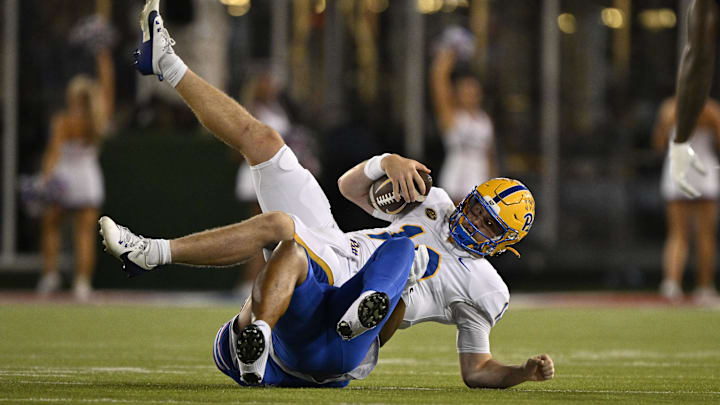 Nov 2, 2024; Dallas, Texas, USA; Pittsburgh Panthers quarterback Eli Holstein (10) is sacked by Southern Methodist Mustangs defensive end Isaiah Smith (58) during the first half at Gerald J. Ford Stadium. Mandatory Credit: Jerome Miron-Imagn Images