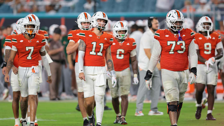 Sep 20, 2025; Miami Gardens, Florida, USA; Miami Hurricanes quarterback Carson Beck (11) and his teammates walk toward the line of scrimmage against the Florida Gators during the fourth quarter at Hard Rock Stadium. Mandatory Credit: Sam Navarro-Imagn Images