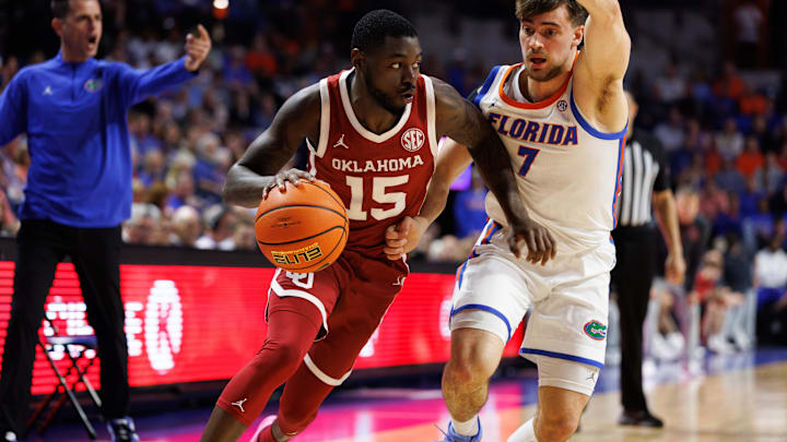 Feb 18, 2025; Gainesville, Florida, USA; Oklahoma Sooners guard Duke Miles (15) drives past Florida Gators guard Urban Klavzar (7) during the first half at Exactech Arena at the Stephen C. O'Connell Center. Mandatory Credit: Matt Pendleton-Imagn Images