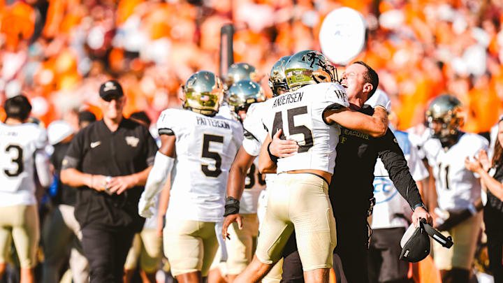Head coach Jake Dickert embraces defensive back Nick Andersen (45) following Wake Forest's 30-23 win over Virginia Tech at Lane Stadium in Blacksburg, VA.