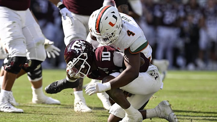Dec 20, 2025; College Station, TX, USA; Texas A&M Aggies quarterback Marcel Reed (10) is sacked by Miami Hurricanes defensive lineman Rueben Bain Jr. (4) during the second half of the first round game of the CFP National Playoff at Kyle Field. Mandatory Credit: Jerome Miron-Imagn Images