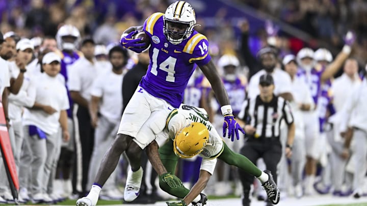 Dec 31, 2024; Houston, TX, USA; Baylor Bears cornerback Caden Jenkins (8) tackles LSU Tigers tight end Trey'Dez Green (14) during the fourth quarter at NRG Stadium. The Tigers defeat the Bears 44-31. Mandatory Credit: Maria Lysaker-Imagn Images 