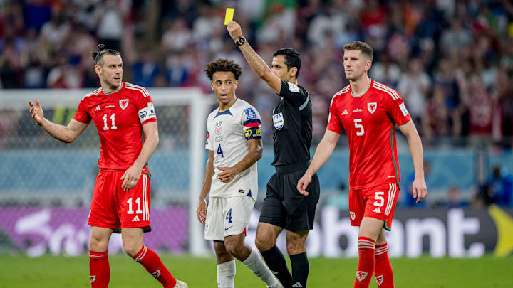 Gareth Bale receives a booking in Wales' World Cup opener against the USA.