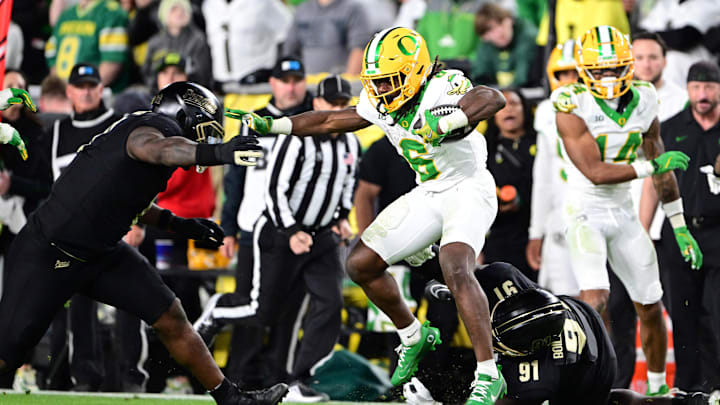 Oct 18, 2024; West Lafayette, Indiana, USA; Oregon Ducks running back Noah Whittington (6) evades tackle by Purdue Boilermakers defensive lineman Cole Brevard (91) during the second half at Ross-Ade Stadium.