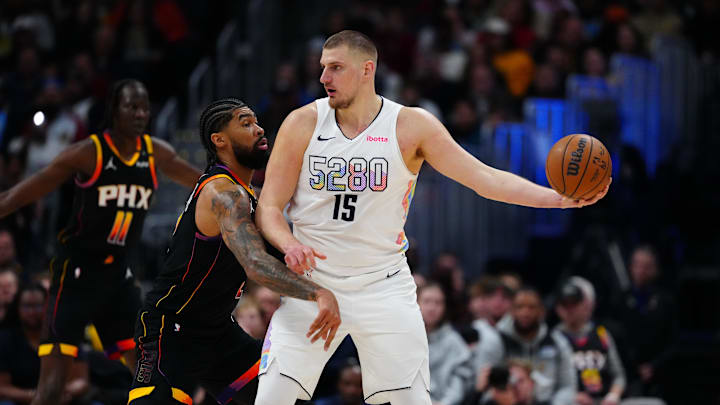 Mar 7, 2025; Denver, Colorado, USA;  Phoenix Suns center Nick Richards (2) defends on Denver Nuggets center Nikola Jokic (15) in the first quarter at Ball Arena. Mandatory Credit: Ron Chenoy-Imagn Images
