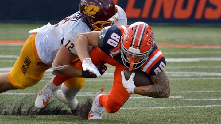Sep 14, 2024; Champaign, Illinois, USA;  Illinois Fighting Illini wide receiver Hank Beatty (80) is brought down by Central Michigan Chippewas linebacker Jordan Kwiatkowski (12) during the second half at Memorial Stadium. Mandatory Credit: Ron Johnson-Imagn Images