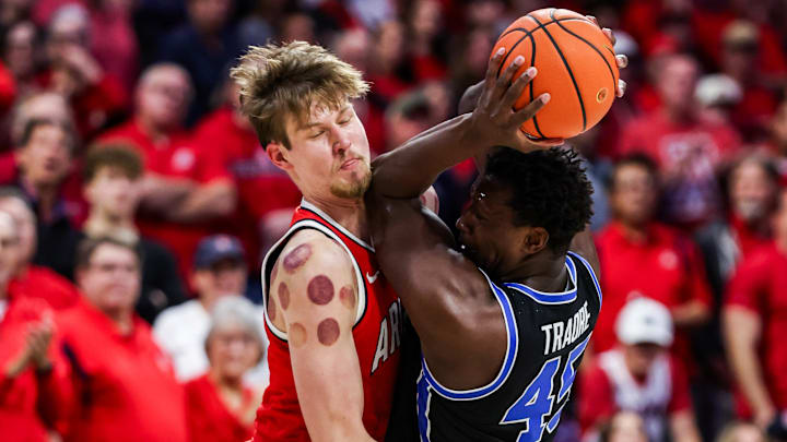 Arizona Wildcats forward Henri Veesaar (13) fouls BYU Cougars forward Fousseyni Traore (45) during the first half at McKale Center.