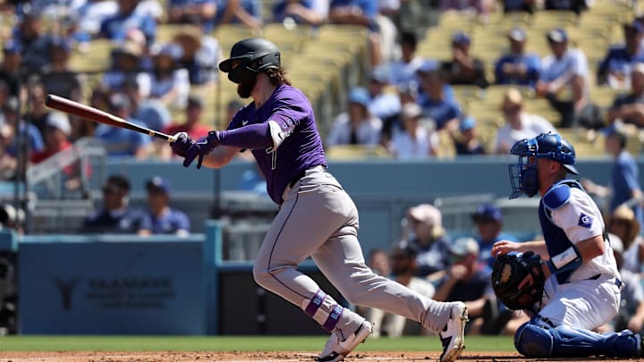 Colorado Rockies second baseman Brendan Rodgers (7) hits an RBI single during the first inning against the Los Angeles Dodgers at Dodger Stadium in 2024.