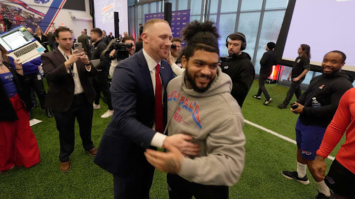 Bills head coach Joe Brady makes his way through players including Ty Johnson who were congratulating Brady and hugging him after the press conference introducing him as the new head coach at the Bills field house in Orchard Park on Jan. 29, 2026.