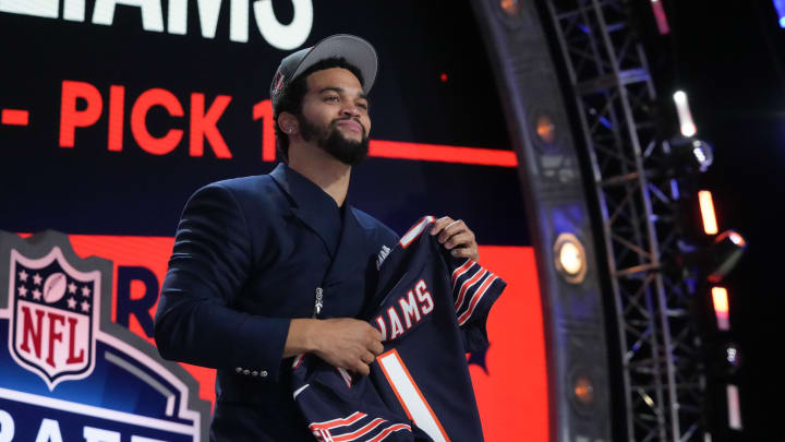Apr 25, 2024; Detroit, MI, USA; Southern California Trojans quarterback Caleb Williams holds up his new Chicago Bears jersey.
