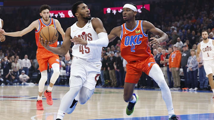 Nov 8, 2023; Oklahoma City, Oklahoma, USA; Cleveland Cavaliers guard Donovan Mitchell (45) drives to the basket against Oklahoma City Thunder guard Shai Gilgeous-Alexander (2) during the first quarter at Paycom Center. Mandatory Credit: Alonzo Adams-Imagn Images