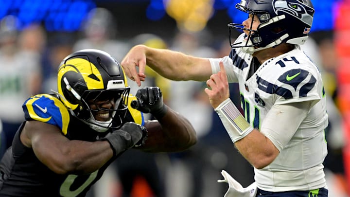 Nov 16, 2025; Inglewood, California, USA;  Seattle Seahawks quarterback Sam Darnold (14) is pressured by Los Angeles Rams linebacker Byron Young (0) at SoFi Stadium. Mandatory Credit: Jayne Kamin-Oncea-Imagn Images