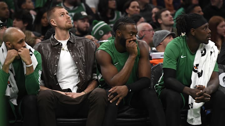 Jan 27, 2024; Boston, Massachusetts, USA;  Boston Celtics center Kristaps Porzingis (8) guard Jaylen Brown (7) and guard Jrue Holiday (4) on the bench during the second half against the LA Clippers at TD Garden. Mandatory Credit: Bob DeChiara-Imagn Images