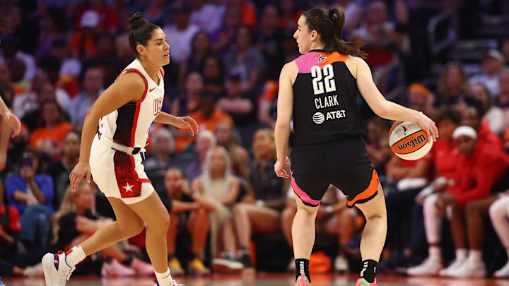 Jul 20, 2024; Phoenix, AZ, USA; Team WNBA guard Caitlin Clark (22) against USA Women's National Team player Kelsey Plum (5) at Footprint Center. Mandatory Credit: Mark J. Rebilas-Imagn Images